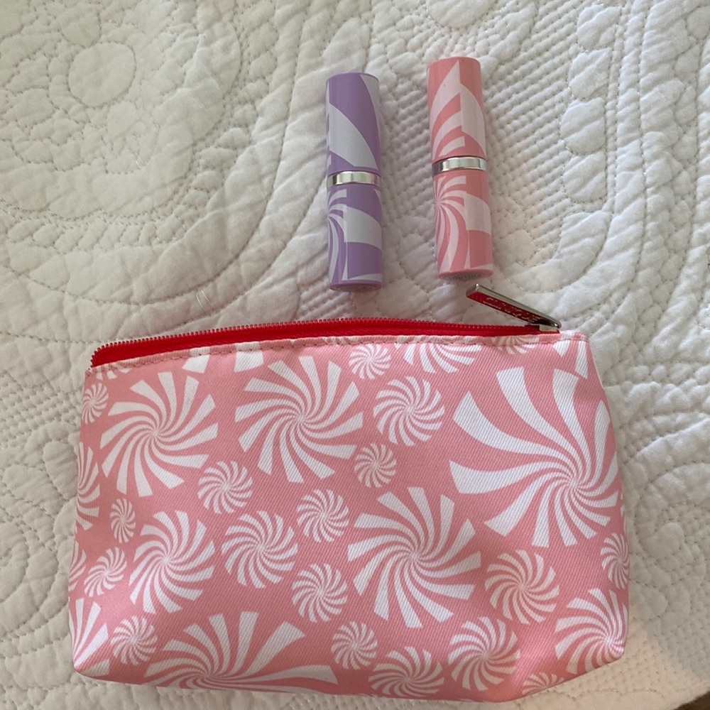 Two Clinique lipsticks and makeup Bag